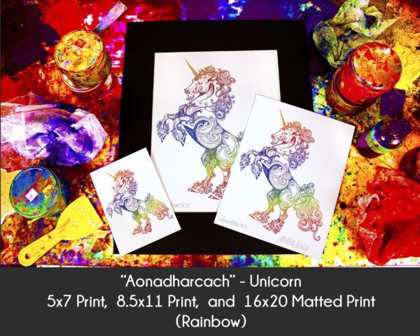Photo of Aonadharcach Unicorn products in 5x7 Print, 8.5x11 Print and 16x20 matted print on an etching inking station to display size differences