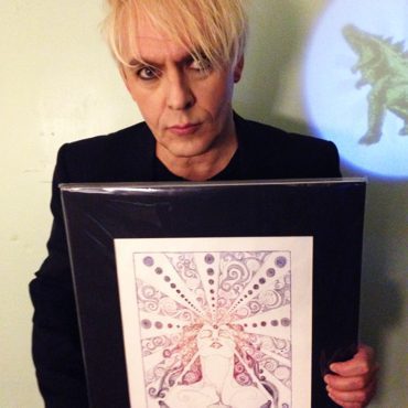 Nick Rhodes of Duran Duran holding Artist Chelsea Smith's original etching print of "The Third Eye" which is apart of her "Sacred Feminine" Series