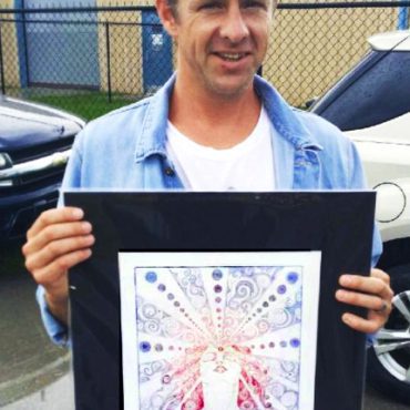 Jon Foreman lead singer of Switchfoot holding up a original fine art etching of "The Third Eye" by Artist Chelsea Smith
